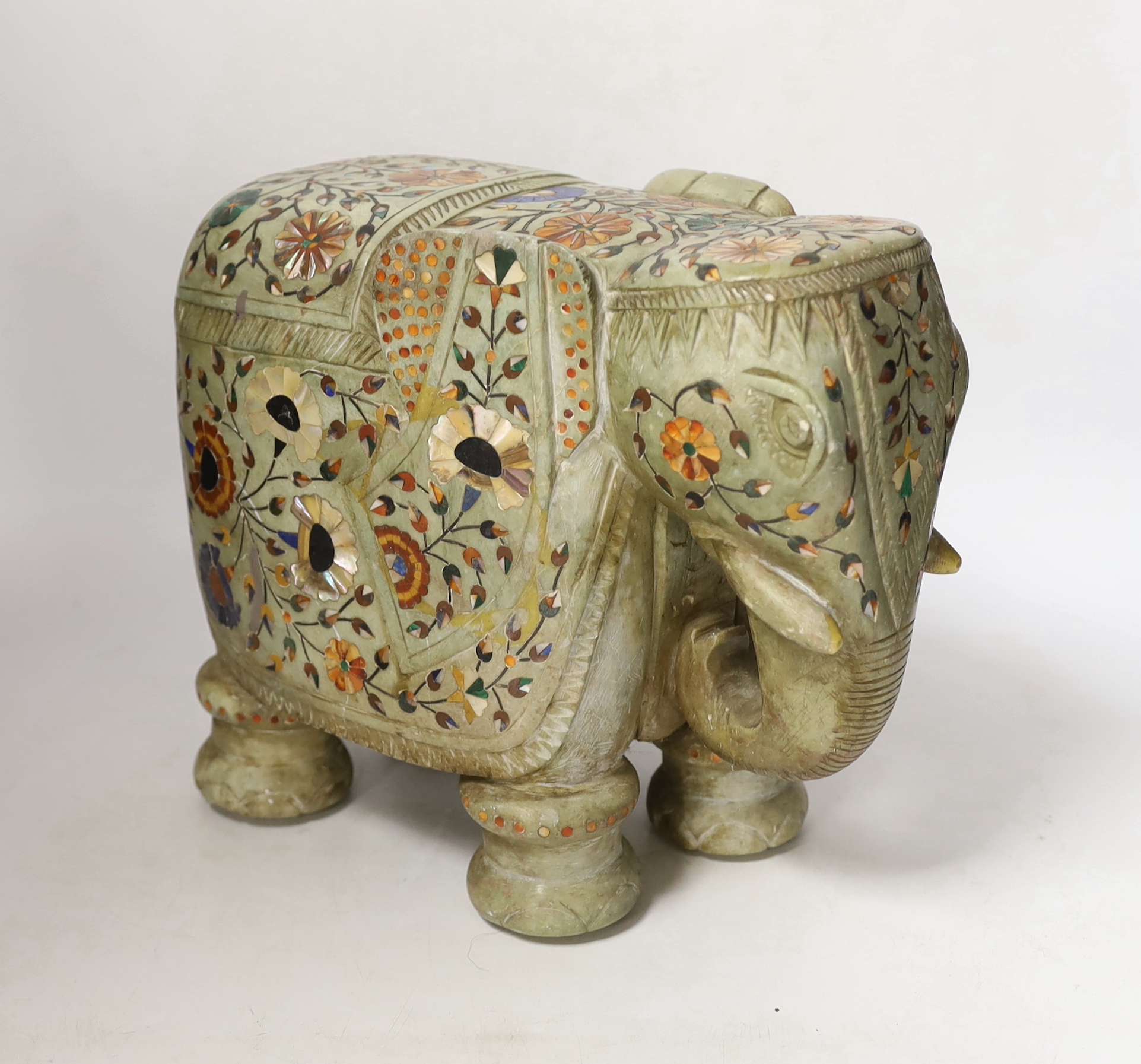 An Indian carved soapstone model of an elephant with semi precious stone inlay, 23cm